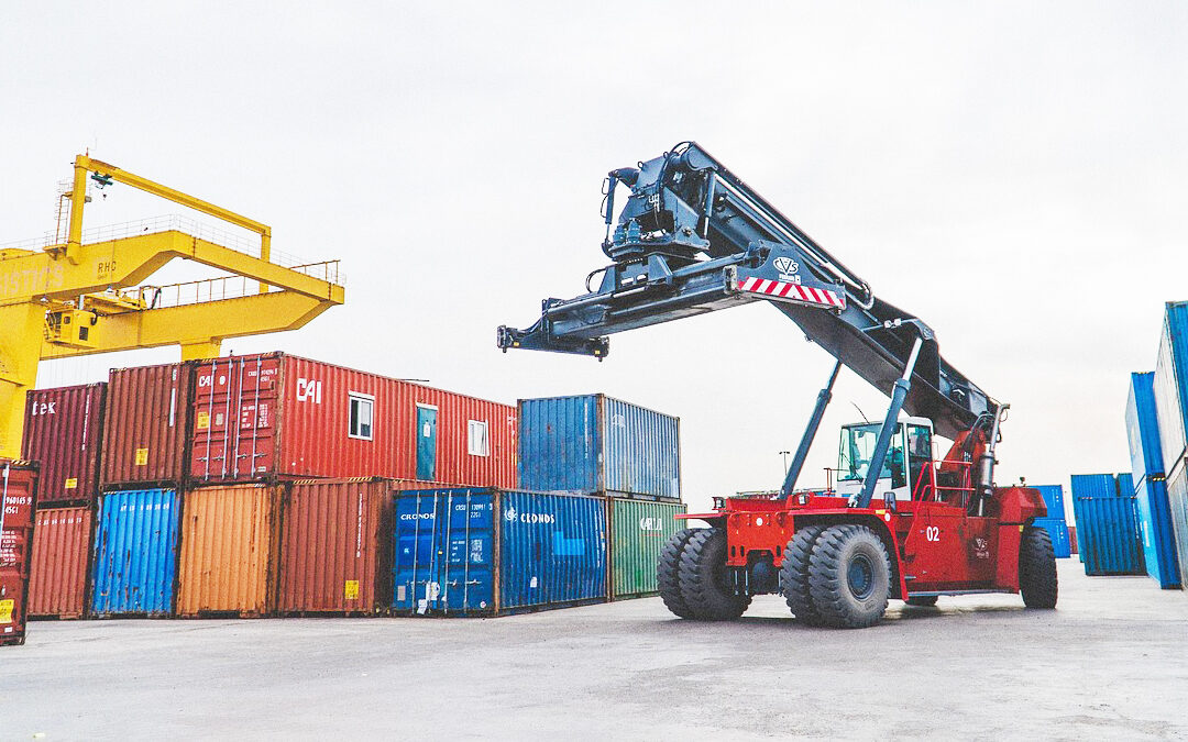 Shipping containers at a freight terminal, representing common customs mistakes and import delays for UK businesses.